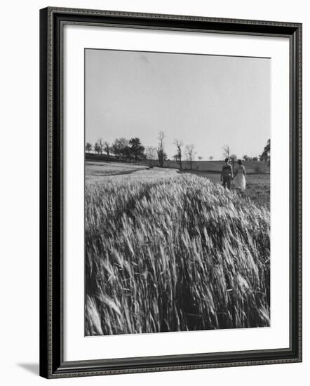 Young Couple Walking by a Grain Field-Ed Clark-Framed Photographic Print