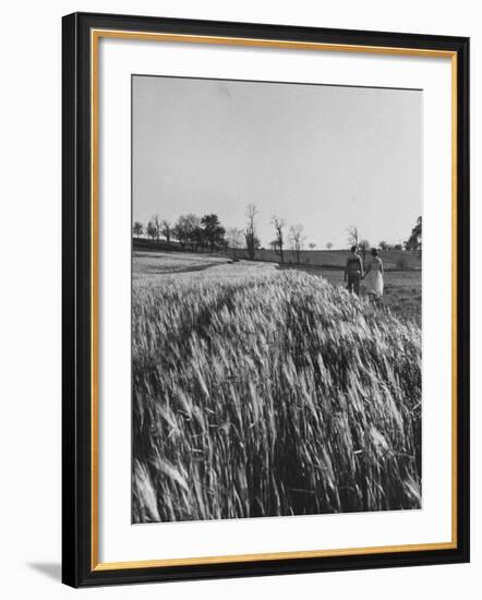 Young Couple Walking by a Grain Field-Ed Clark-Framed Photographic Print