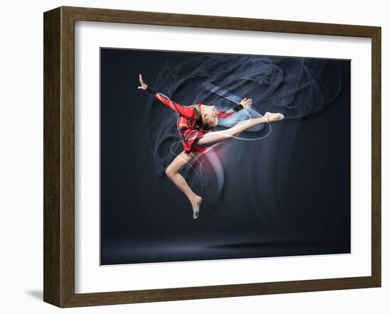 Young Cute Woman In Gymnast Suit Show Athletic Skill On Black Background-Sergey Nivens-Framed Art Print