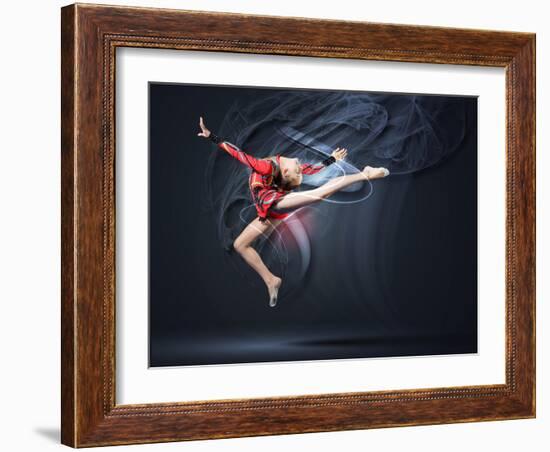 Young Cute Woman In Gymnast Suit Show Athletic Skill On Black Background-Sergey Nivens-Framed Art Print