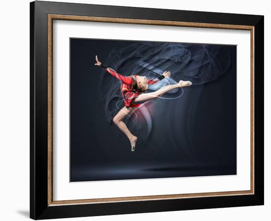 Young Cute Woman In Gymnast Suit Show Athletic Skill On Black Background-Sergey Nivens-Framed Art Print