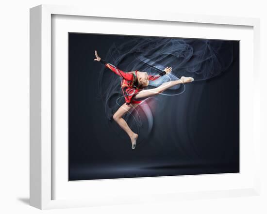 Young Cute Woman In Gymnast Suit Show Athletic Skill On Black Background-Sergey Nivens-Framed Art Print