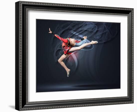 Young Cute Woman In Gymnast Suit Show Athletic Skill On Black Background-Sergey Nivens-Framed Art Print