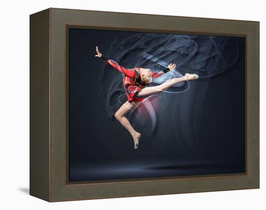 Young Cute Woman In Gymnast Suit Show Athletic Skill On Black Background-Sergey Nivens-Framed Stretched Canvas