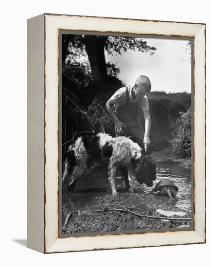 Young Farm Boy Watching His Dog Sniff a Large Turtle at the Pond-Myron Davis-Framed Premier Image Canvas