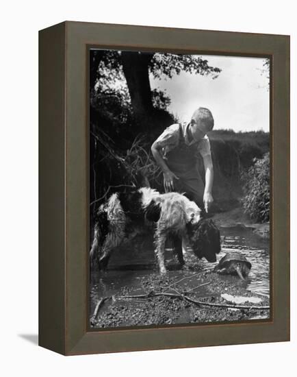 Young Farm Boy Watching His Dog Sniff a Large Turtle at the Pond-Myron Davis-Framed Premier Image Canvas