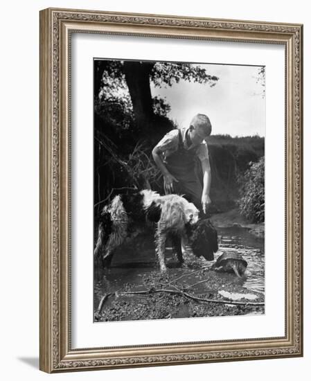 Young Farm Boy Watching His Dog Sniff a Large Turtle at the Pond-Myron Davis-Framed Photographic Print