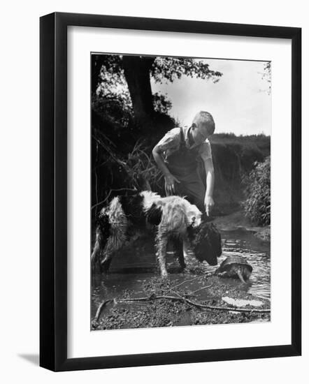 Young Farm Boy Watching His Dog Sniff a Large Turtle at the Pond-Myron Davis-Framed Photographic Print