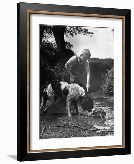 Young Farm Boy Watching His Dog Sniff a Large Turtle at the Pond-Myron Davis-Framed Photographic Print