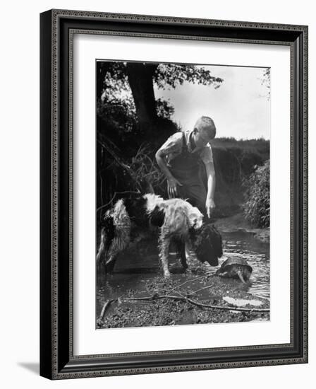 Young Farm Boy Watching His Dog Sniff a Large Turtle at the Pond-Myron Davis-Framed Photographic Print