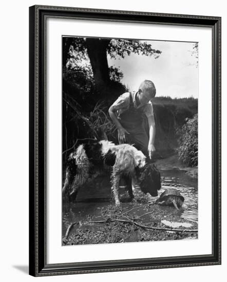 Young Farm Boy Watching His Dog Sniff a Large Turtle at the Pond-Myron Davis-Framed Photographic Print