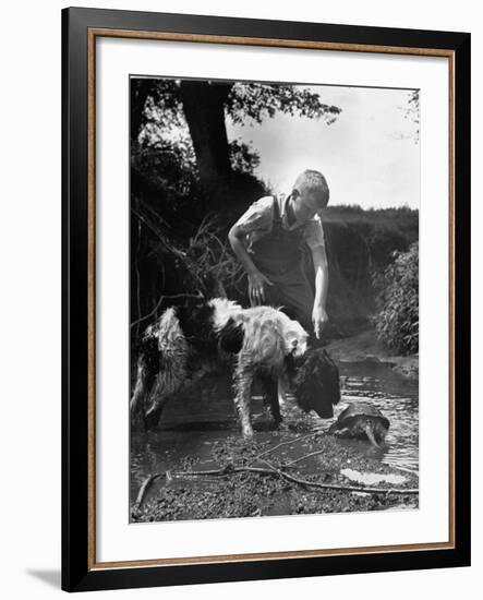 Young Farm Boy Watching His Dog Sniff a Large Turtle at the Pond-Myron Davis-Framed Photographic Print