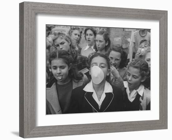 Young Girl Blowing a Bubble with Her Friends Watching-Bob Landry-Framed Photographic Print