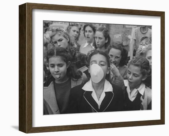 Young Girl Blowing a Bubble with Her Friends Watching-Bob Landry-Framed Photographic Print