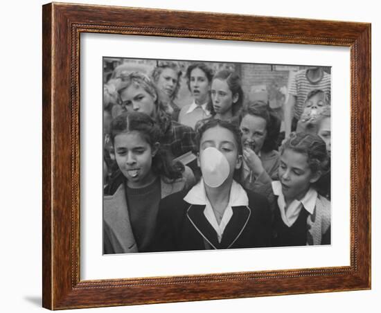 Young Girl Blowing a Bubble with Her Friends Watching-Bob Landry-Framed Photographic Print