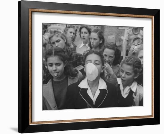 Young Girl Blowing a Bubble with Her Friends Watching-Bob Landry-Framed Photographic Print