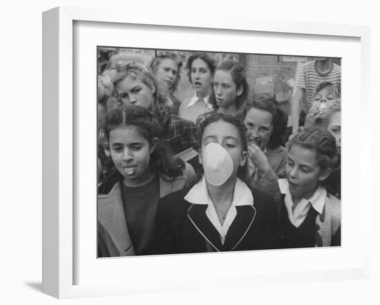 Young Girl Blowing a Bubble with Her Friends Watching-Bob Landry-Framed Photographic Print