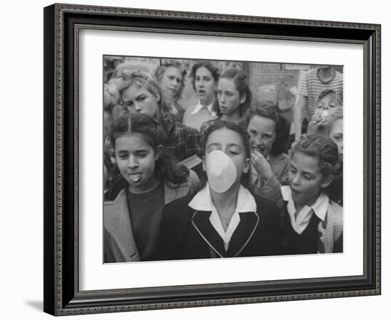 Young Girl Blowing a Bubble with Her Friends Watching-Bob Landry-Framed Photographic Print