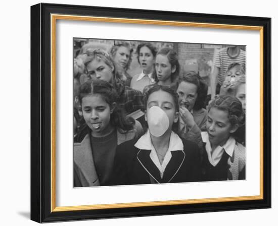 Young Girl Blowing a Bubble with Her Friends Watching-Bob Landry-Framed Photographic Print