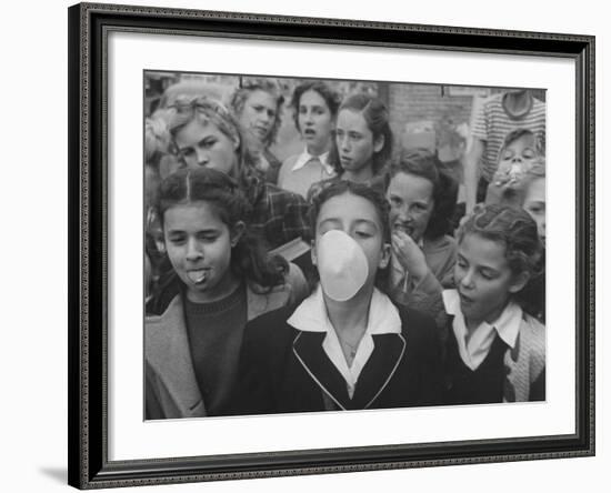 Young Girl Blowing a Bubble with Her Friends Watching-Bob Landry-Framed Photographic Print