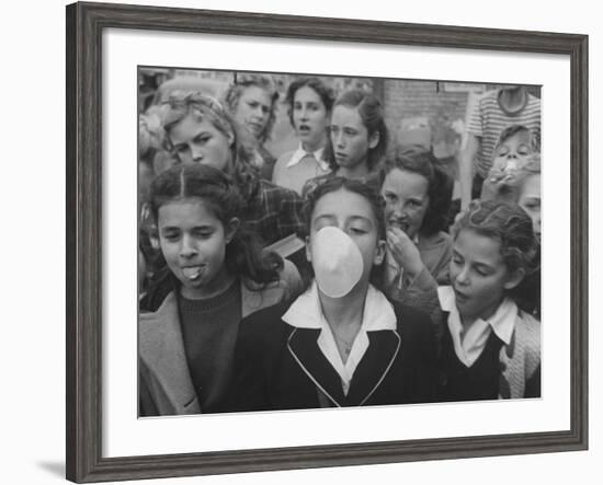 Young Girl Blowing a Bubble with Her Friends Watching-Bob Landry-Framed Photographic Print