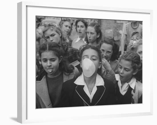 Young Girl Blowing a Bubble with Her Friends Watching-Bob Landry-Framed Photographic Print