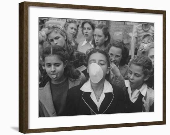 Young Girl Blowing a Bubble with Her Friends Watching-Bob Landry-Framed Photographic Print