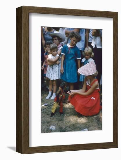 Young Girl in a Bonnet and a Red Dress Feeding an Organ Grinder's Monkey, Iowa State Fair, 1955-John Dominis-Framed Photographic Print