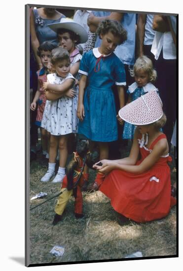 Young Girl in a Bonnet and a Red Dress Feeding an Organ Grinder's Monkey, Iowa State Fair, 1955-John Dominis-Mounted Photographic Print