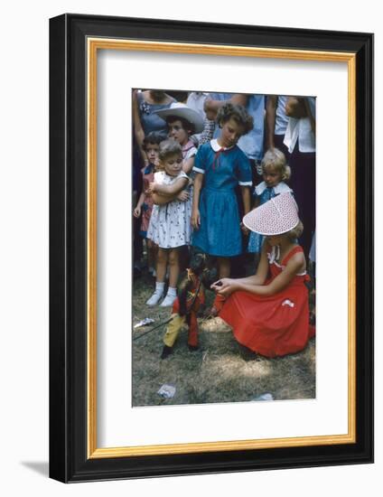 Young Girl in a Bonnet and a Red Dress Feeding an Organ Grinder's Monkey, Iowa State Fair, 1955-John Dominis-Framed Photographic Print