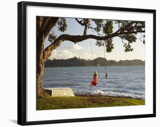 Young Girl on Rope Swing under Pohutukawa Tree, Oamaru Bay, Coromandel, North Island, New Zealand-David Wall-Framed Photographic Print