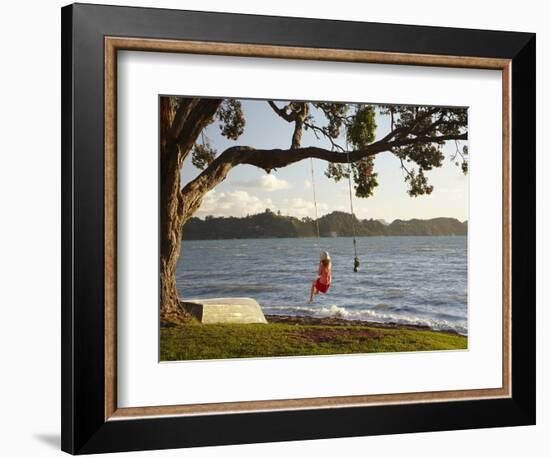 Young Girl on Rope Swing under Pohutukawa Tree, Oamaru Bay, Coromandel, North Island, New Zealand-David Wall-Framed Photographic Print