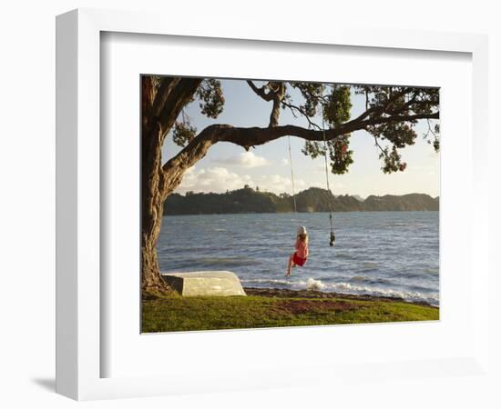 Young Girl on Rope Swing under Pohutukawa Tree, Oamaru Bay, Coromandel, North Island, New Zealand-David Wall-Framed Photographic Print