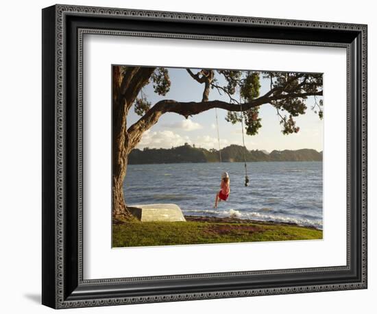 Young Girl on Rope Swing under Pohutukawa Tree, Oamaru Bay, Coromandel, North Island, New Zealand-David Wall-Framed Photographic Print