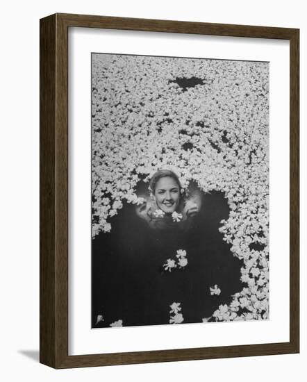 Young Girl Swimming in Pool Covered with Gardenia Blossoms-Eliot Elisofon-Framed Photographic Print