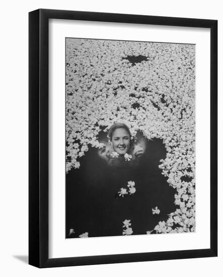 Young Girl Swimming in Pool Covered with Gardenia Blossoms-Eliot Elisofon-Framed Photographic Print