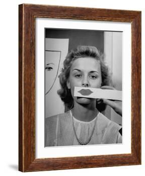 Young Girl Trying to Determine Which Lipstick Color Will Look Right with Her Complextion-Nina Leen-Framed Photographic Print