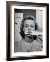 Young Girl Trying to Determine Which Lipstick Color Will Look Right with Her Complextion-Nina Leen-Framed Photographic Print