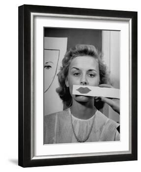 Young Girl Trying to Determine Which Lipstick Color Will Look Right with Her Complextion-Nina Leen-Framed Photographic Print