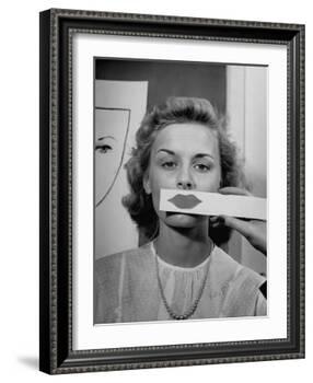 Young Girl Trying to Determine Which Lipstick Color Will Look Right with Her Complextion-Nina Leen-Framed Photographic Print