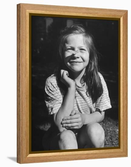 Young Girl with Long Hair and Raggedy Shirt, Smiling, Wearing Seed Pod on Nose-Ralph Morse-Framed Premier Image Canvas