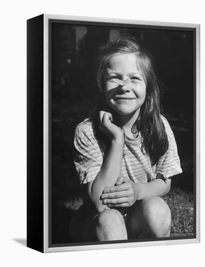 Young Girl with Long Hair and Raggedy Shirt, Smiling, Wearing Seed Pod on Nose-Ralph Morse-Framed Premier Image Canvas