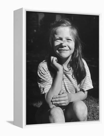 Young Girl with Long Hair and Raggedy Shirt, Smiling, Wearing Seed Pod on Nose-Ralph Morse-Framed Premier Image Canvas