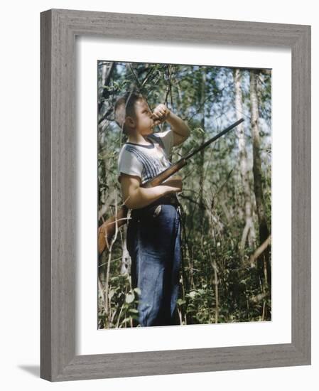 Young Hunter Blowing a Duck Decal Wistle while Holding His Rifle under His Arm-Al Fenn-Framed Photographic Print