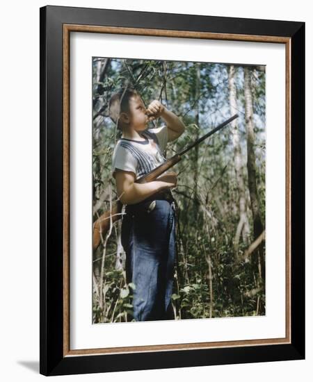 Young Hunter Blowing a Duck Decal Wistle while Holding His Rifle under His Arm-Al Fenn-Framed Photographic Print