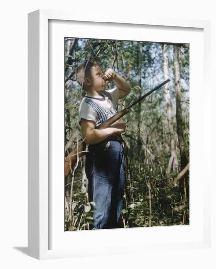 Young Hunter Blowing a Duck Decal Wistle while Holding His Rifle under His Arm-Al Fenn-Framed Photographic Print