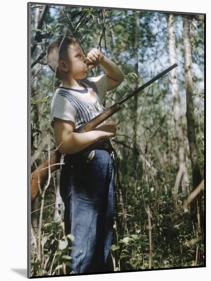 Young Hunter Blowing a Duck Decal Wistle while Holding His Rifle under His Arm-Al Fenn-Mounted Photographic Print