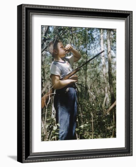 Young Hunter Blowing a Duck Decal Wistle while Holding His Rifle under His Arm-Al Fenn-Framed Photographic Print