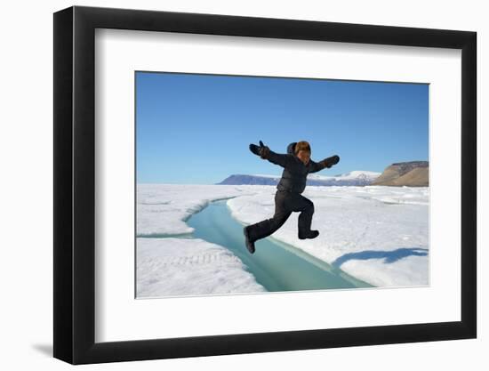 Young Inuit Boy Jumping over a Crack on Ice Floe, Ellesmere Island, Nanavut, Canada, June 2012-Eric Baccega-Framed Photographic Print