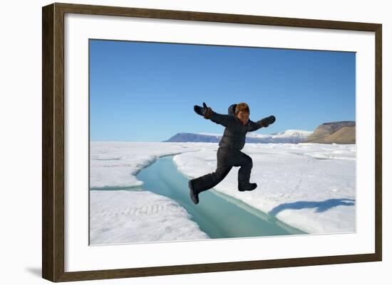 Young Inuit Boy Jumping over a Crack on Ice Floe, Ellesmere Island, Nanavut, Canada, June 2012-Eric Baccega-Framed Photographic Print